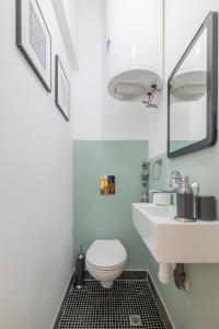 a bathroom with a toilet and a sink and a mirror at blueWaveplace - Contemporary Home in Center of Sofia in Sofia +13 photos