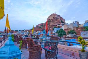 a table and chairs with a view of a city at Singhvi's Haveli in Jodhpur