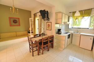 a kitchen with a table and a couch in a room at Elena Apartments Corfu in Acharavi