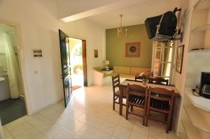a kitchen and dining room with a table and chairs at Elena Apartments Corfu in Acharavi