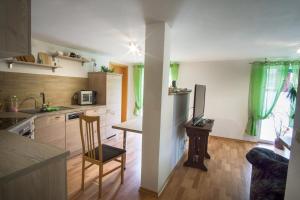 a kitchen with a table and a desk with a television at Ferienwohnung in der Telle in Schmalkalden