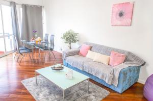 
a living room with a couch and a table at Arcadas Cozy Apartments - AV in Funchal

