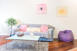 
a living room with a couch and a table at Arcadas Cozy Apartments - AV in Funchal
