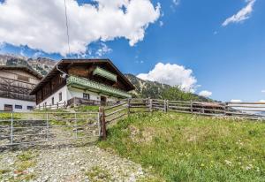 a house on a hill with a fence at Almliesl RAUR-437 in Rauris