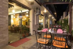 a patio with a table with chairs and a restaurant at Hotel Queens Park in Pokhara