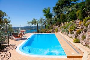 a swimming pool with a view of the water at Villa Panorama Residence in Gardone Riviera