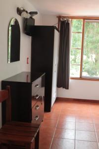 a living room with a dresser and a window at Hotel La Ballena in Punta del Este