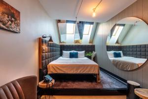 a small room with a bed and a mirror at Hotel Rum Budapest in Budapest