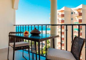 a balcony with a table and two chairs at APARTAMENTO EN LA PLAYA CON VISTAS DE ENSUEÑO in Almuñécar