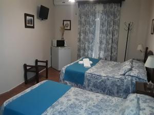 Ein Bett oder Betten in einem Zimmer der Unterkunft Hostal Rocio