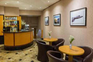 a restaurant with two tables and chairs and a bar at Hotel Vermont Ipanema in Rio de Janeiro