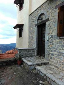 a building with a door and steps in front of it at Holiday Apartments in Arachova in Arachova