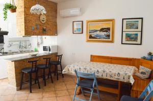 a kitchen and dining room with a table and chairs at Casa Maria in Carloforte