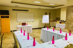 a room with white tables with pink bottles on them at Hotel Vermont Ipanema in Rio de Janeiro