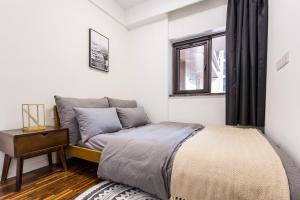a bedroom with a bed and a window at Wuhan Hongshan·Jiedaokou· Locals Apartment 00116860 in Wuhan