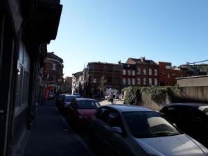 a row of parked cars on a city street at Leonard room in Liège +15 photos