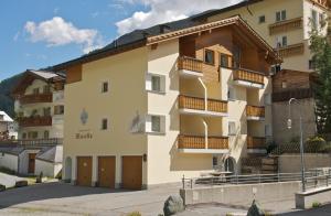 a large apartment building with wooden balconies at Haus Musella in Samnaun