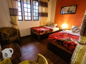 Giường trong phòng chung tại Nuwara Eliya Hills Rest