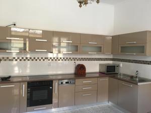 a kitchen with stainless steel appliances and brown cabinets at Anastasia in Mediaş