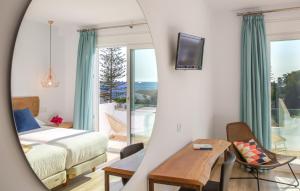 a bedroom with a bed and a view of the ocean at Fortuna in Los Caños de Meca