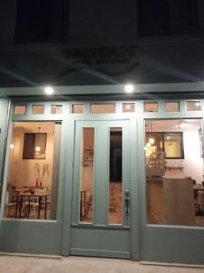 a front door of a building with a table and chairs at Hotel Boutique Valverde Santa Elena in San Salvador