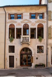 a building with a balcony on the front of it at Casa Archè in Feltre