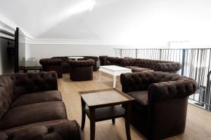a waiting room with leather couches and a table at Hotel De Ville in Genoa