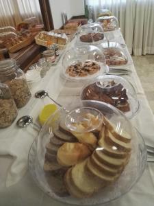a table with many plates of pastries on it at Villa La Rena in Anagni