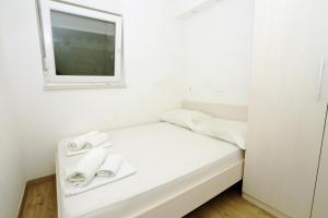 Postel nebo postele na pokoji v ubytování Apartments Dora