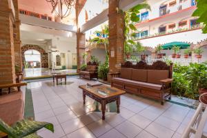 a lobby with couches and tables in a building at Hotel Encino Malecón Centro Puerto Vallarta in Puerto Vallarta