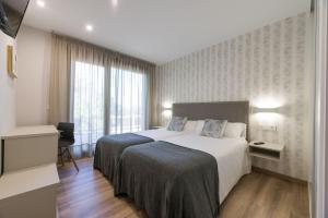 Postel nebo postele na pokoji v ubytování Hotel A Curuxa Wellness