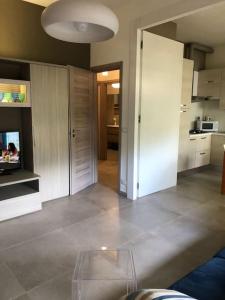 a kitchen with white cabinets and a glass table at casa Fantulìn Mare in Laigueglia +35 photos