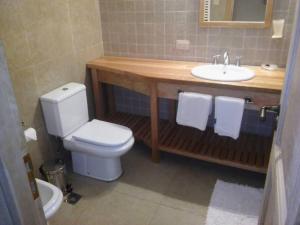 a bathroom with a white toilet and a sink at Villa Gutierrez Braun in San Martín de los Andes +29 photos