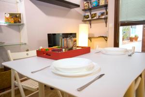 a table with two white plates on top of it at Apartamento Ciudad Monumental in Cáceres