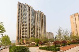 a large building with tall buildings in a city at Qingdao Shibei·Kaide Mall· Locals Apartment 00151110 in Qingdao