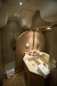 a bathroom with a sink and a shower with a mirror at Riad Zamzam in Marrakesh
