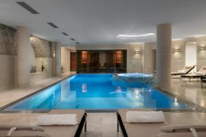 a large swimming pool in a hotel room at Grand Hotel Kempinski Vilnius in Vilnius