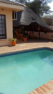 een huis met een groot zwembad voor een huis bij TINTECH BED & BREAKFAST in Francistown