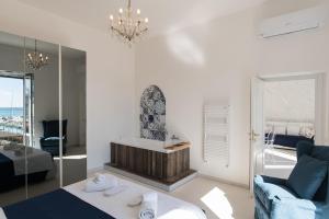 a living room with a bed and a mirror at Relais Mareluna - Luxury Apartments in Salerno