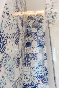 a room with blue and white tiles on a wall at Relais Mareluna - Luxury Apartments in Salerno