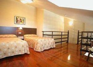 Un ou plusieurs lits dans un hébergement de l'établissement Apartamento Dúplex en Boo de Piélagos