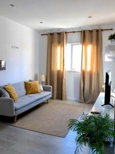 a living room with a couch and a window at Apartamento de la Candelaria I in Santa Cruz de Tenerife