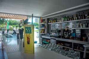a bar with a yellow sign on the counter at Flor Da Rocha in Portimão