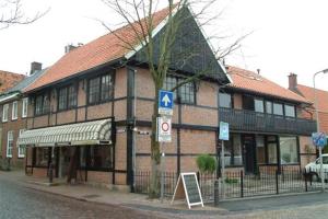 a large brick building with a sign in front of it at La vita e bella in Ootmarsum