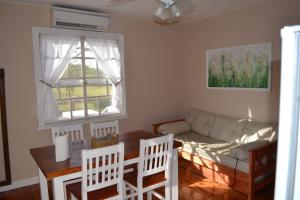 a living room with a table and a couch at Cabañas Puerto Trinidad in Tigre