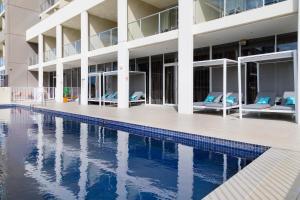 a hotel room with a pool and lounge area at Sage Hotel Wollongong in Wollongong