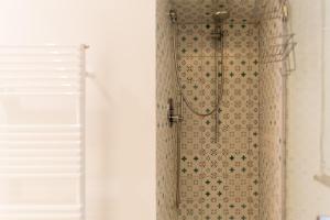 a shower in a bathroom next to a window at Relais Mareluna - Luxury Apartments in Salerno