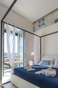 Postel nebo postele na pokoji v ubytování Relais Mareluna - Luxury Apartments