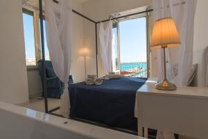 a bedroom with a bed with a large mirror at Relais Mareluna - Luxury Apartments in Salerno