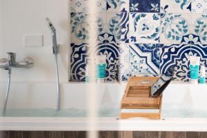 a bathroom with blue and white tiles and a shower at Relais Mareluna - Luxury Apartments in Salerno